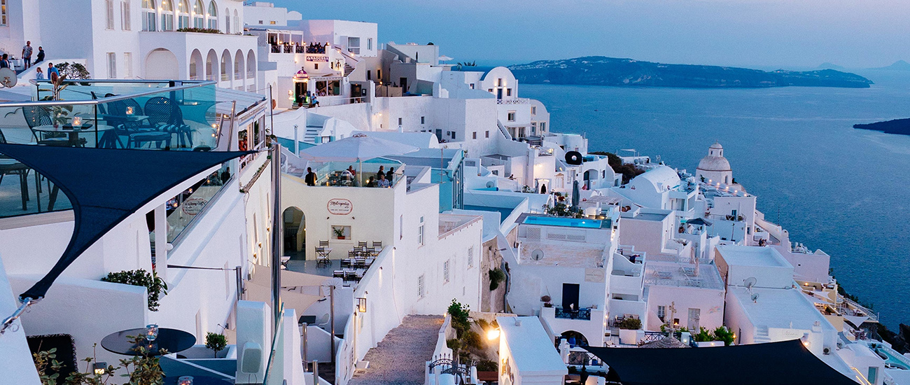 A vertical high angle shot of the white buildings in Santorini, Greece